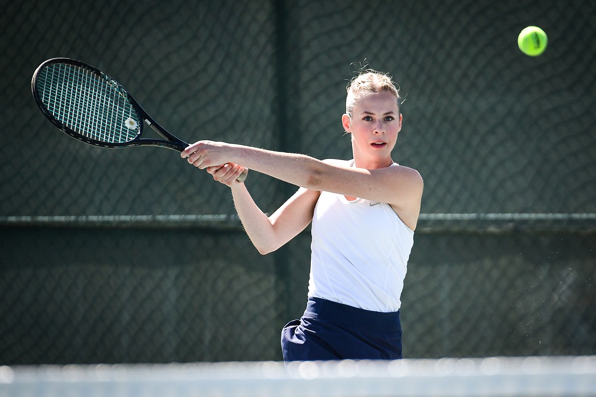 Glacier's Sarah Downs hits a backhand return in a girls doubles match with teammate Haven Speer against Missoula Big Sky's Kadyn Easter and Amber Williams at the Western AA Invite at FVCC on Saturday, April 29. (Casey Kreider/Daily Inter Lake)