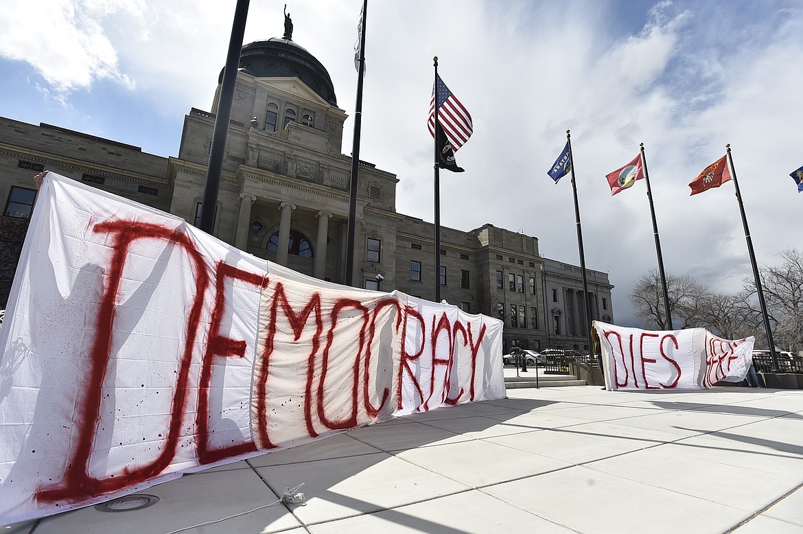 Demonstrators hold a sign that reads "Democracy Dies Here," on the steps of the Montana State Capitol, in Helena, Mont., Monday, April 24, 2023. (Thom Bridge/Independent Record via AP)