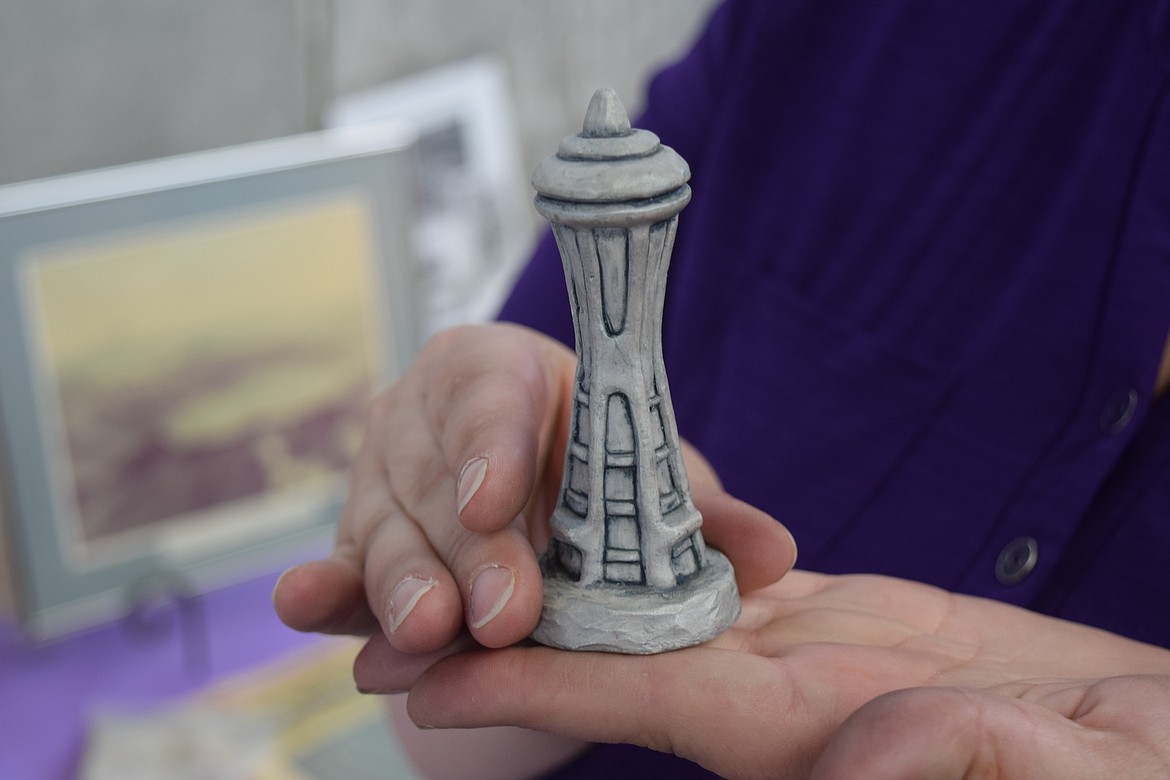 Stephanie Massart, regent of the Karneetsa Chapter of the National Society of the Daughters of the American Revolution, holds up a small model of the Space Needle made of volcanic ash from the eruption of Mt. St. Helens on May 18, 1980.