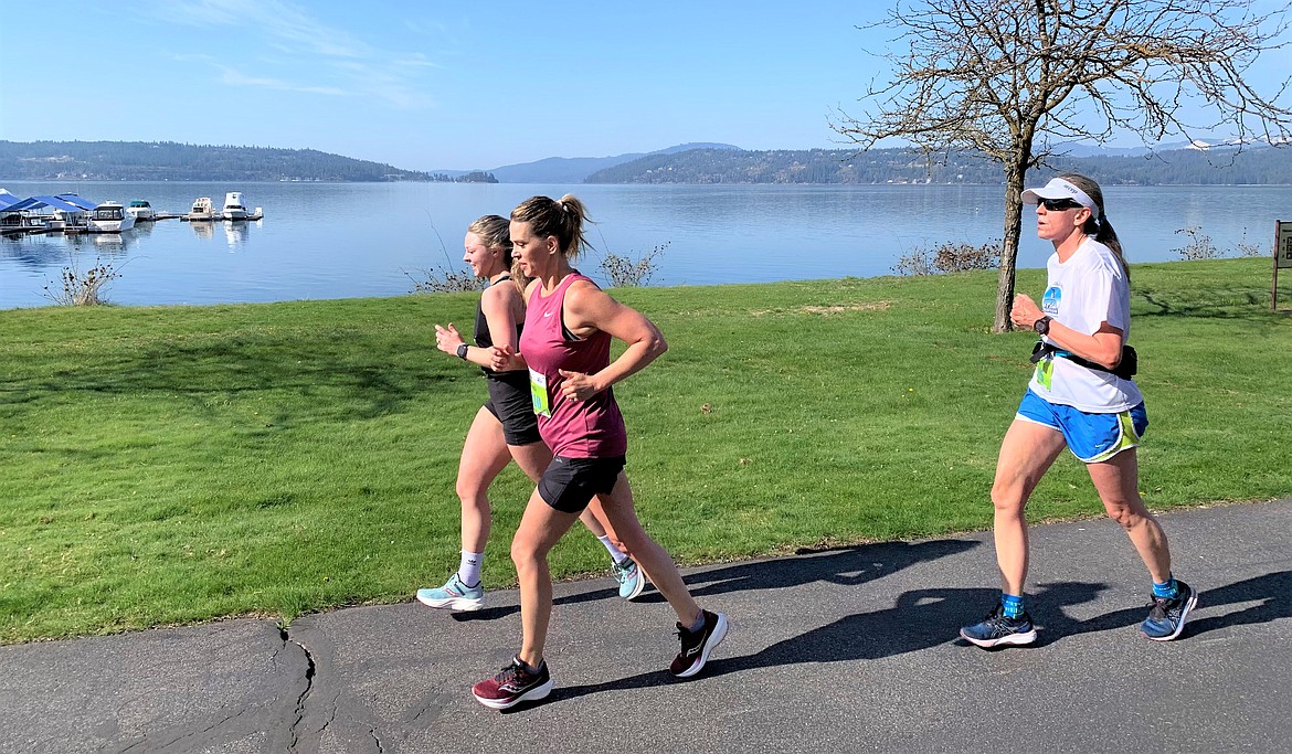 Runners make their way along the North Idaho Centennial Trail with Lake Coeur d'Alene in the background during the Spring Dash on Saturday.