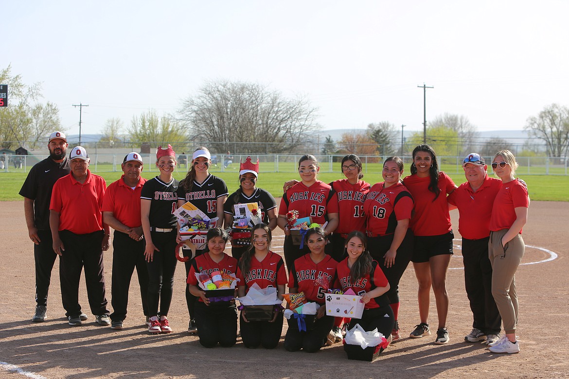 Othello seniors from the varsity and junior varsity teams smile for photos after the team’s senior night ceremony.