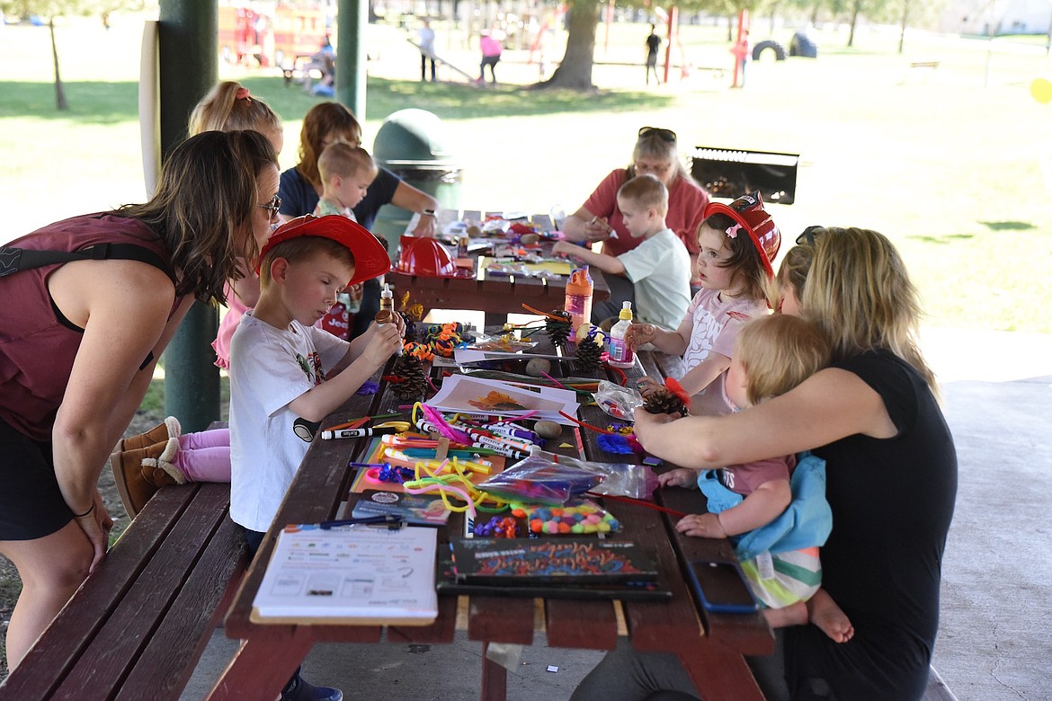 Making pine cone critters was a popular activity at Fireman Park in Libby on Friday, April 28, during Arbor Day festivities. (Scott Shindledecker/The Western News)
