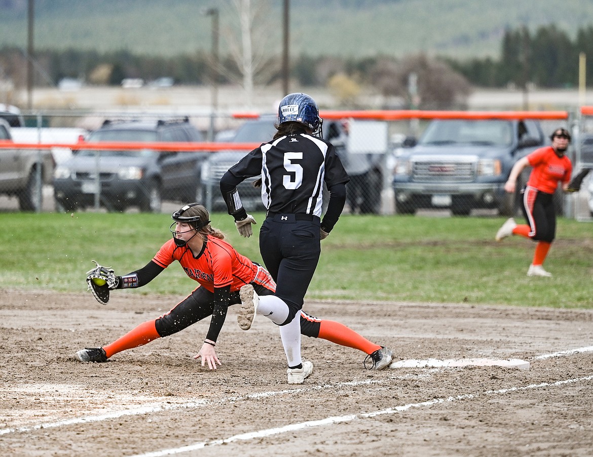 Ronan's Brogan Youngren stretches to get the out in last week's softball game against Mission-Arlee-Charlo (MAC). (Christa Umphrey photo)