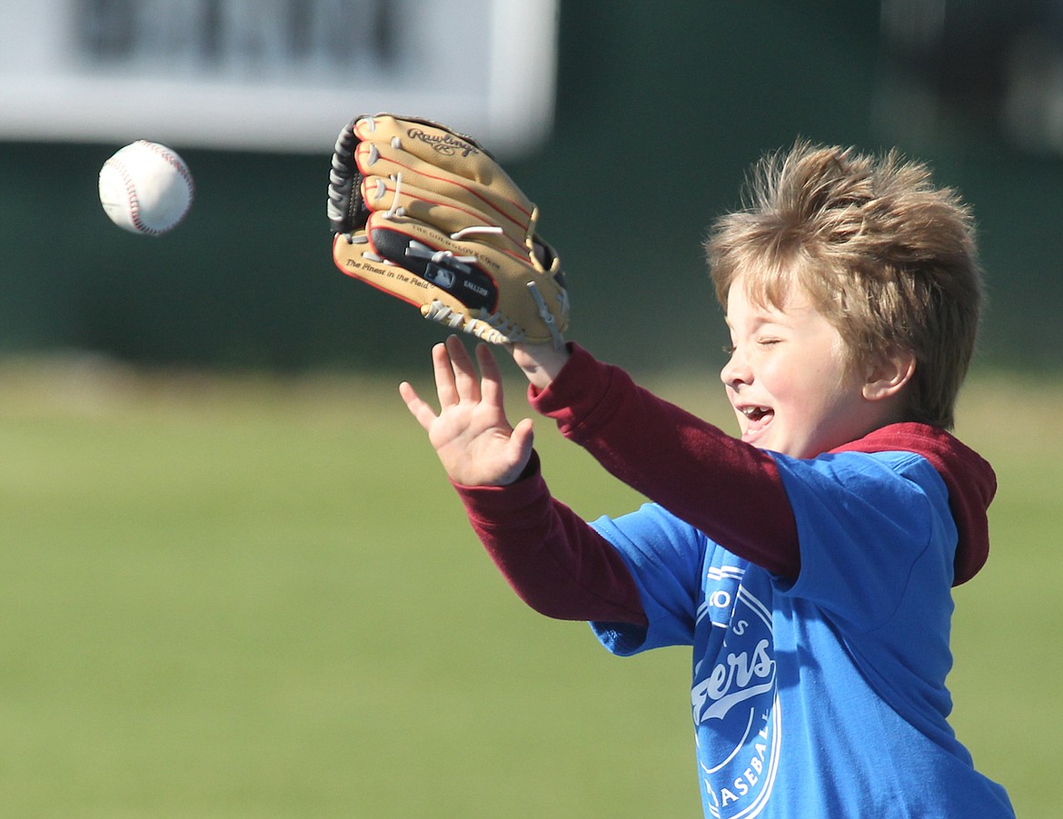 Wilder Benefield, 6, reaches for a fly ball during the Libby Loggers Baseball Camp on Saturday, April 29 at Lee Gehring Field. (Paul Sievers/The Western News)