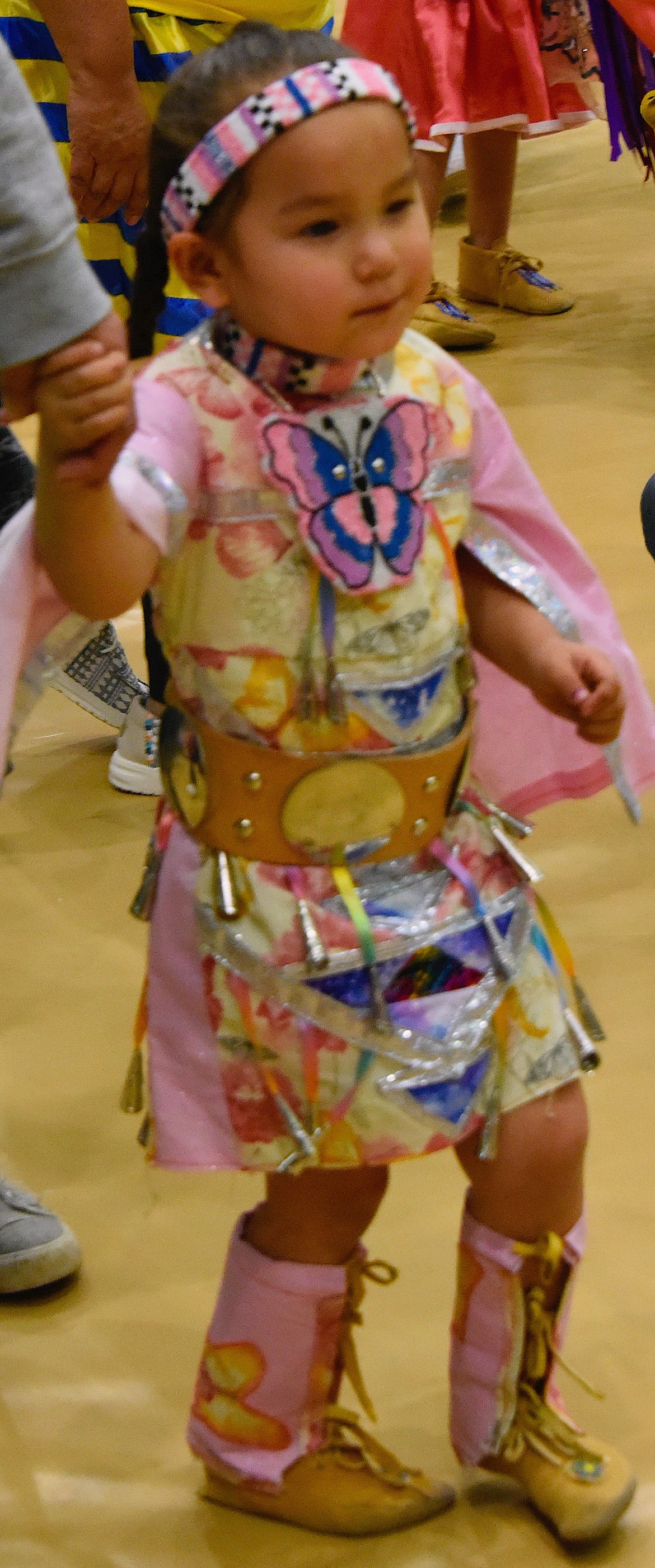 Nyjah Butterfly, 3, dances at the Head Start Pow-wow with beaded butterflies in her hair.