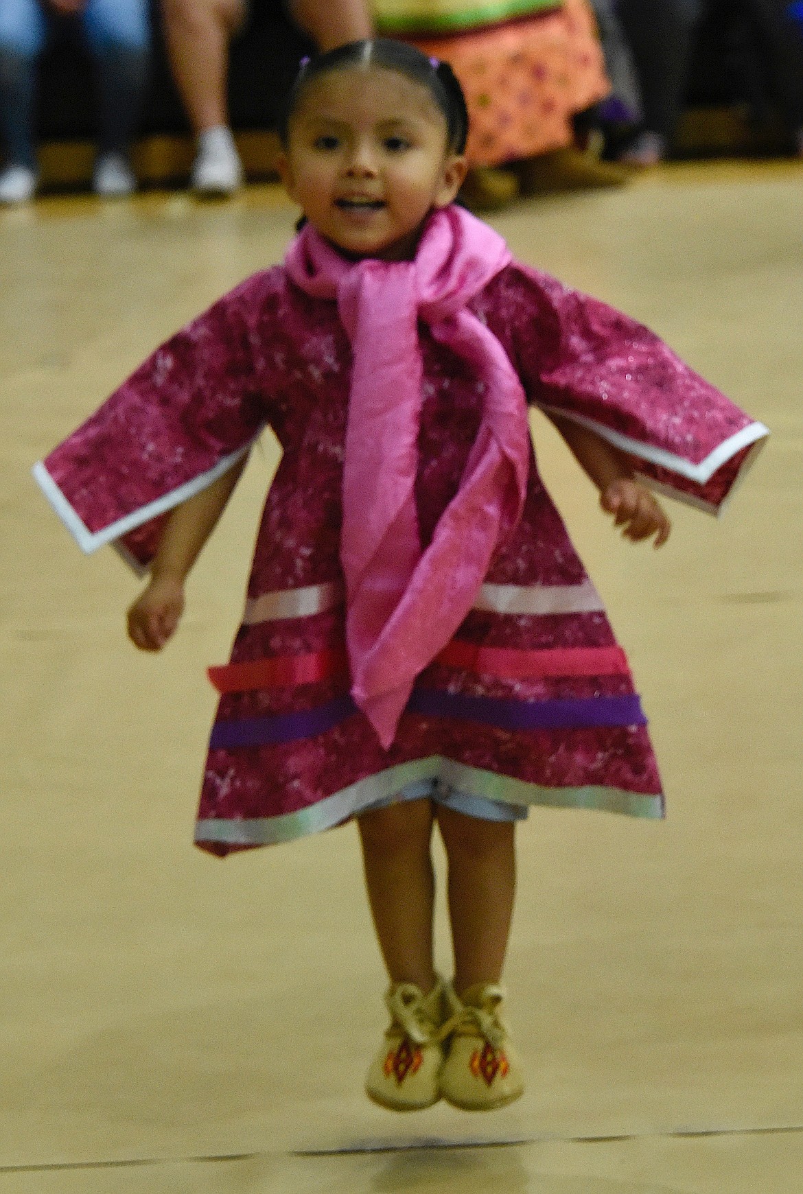 Alazae Martinex, 2, catches some air as she dances at the Head Start Pow-wow. (Berl Tiskus/Leader)