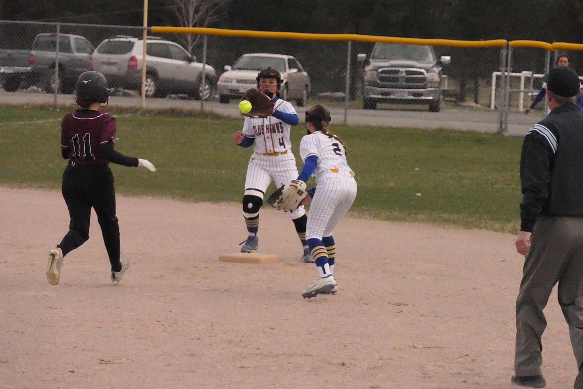 Lady Hawks infielder MacKenzie Robinson (2) flips to shortstop Olivia Fitchett to get the lead runner at second base during their game with Troy last week in T Falls.  (Chuck Bandel/VP-MI)