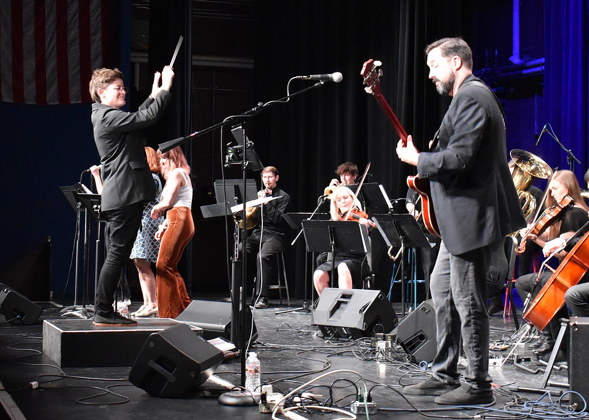 Conductor Kim Roy, left, leads Friday night’s performance with great enthusiasm while the Seattle Rock Orchestra’s founder and artistic director, Scott Teske, plays electric bass.