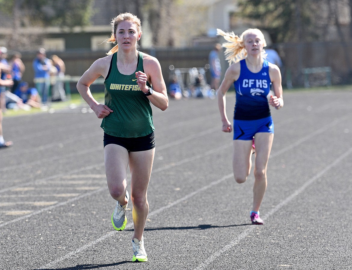 Whitefish junior Maeve Ingelfinger takes the lead over Columbia Falls' Siri Erickson in the women's 1600 meter race at the Whitefish A.R.M. on Saturday. (Whitney England/Whitefish Pilot)