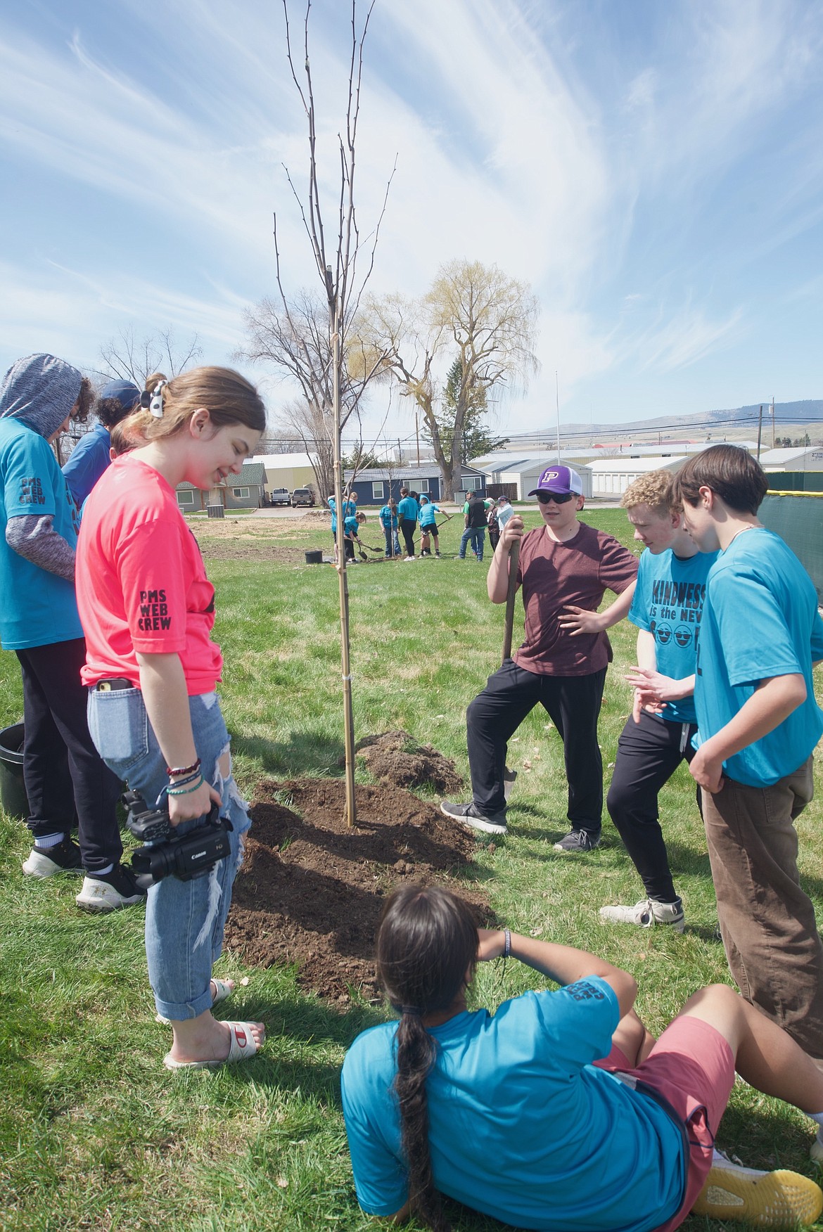 Eighth graders from Polson Middle School rest on their laurels after planting trees. (Kristi Niemeyer/Leader)