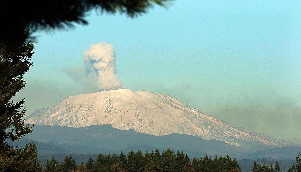 Falling rocks at the snow-covered Mount St. Helens in Washington, kick up a dust plume that rises above the rim of the volcano's crater, Tuesday, Nov. 22, 2005. This photo was taken from the Ridgefield High School in Ridgefield, Wash. Mount St. Helens rumbled back to life in 2004 after years of quiet, with a flow of molten rock reaching the surface. In 1980, an eruption killed 57 people.