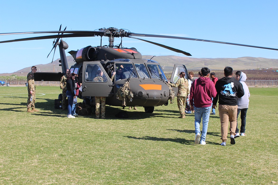 Wahluke High School students take a look at the helicopter that flew in for Outdoor Career Day, courtesy of the Washington Army National Guard.