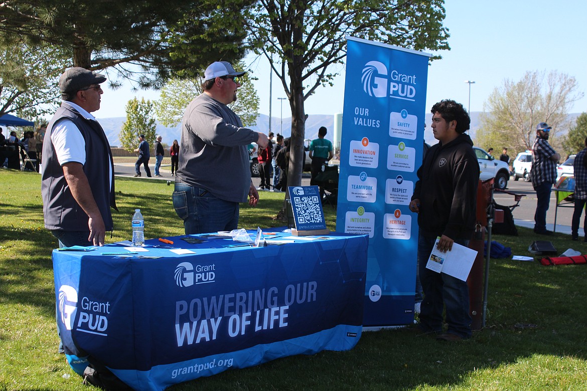 Grant County PUD employees Luis Sanchez, left, and John Kemman, center, talk with Wahluke student Adrian Martinez about career opportunities.