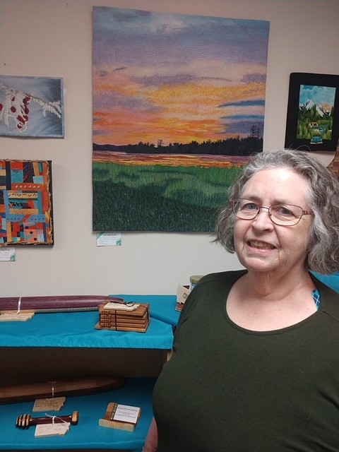 Fiber artist Maureen Louden is shown with her art pieces at Paint, Metal & Mud, an artists' cooperative and gallery in downtown Kalispell.