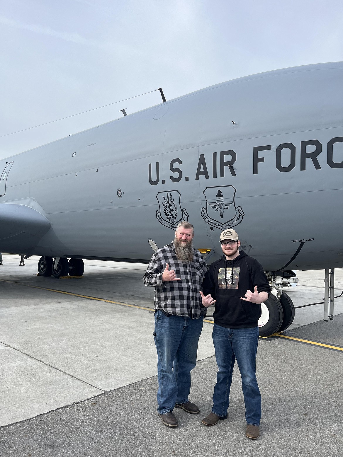 Lakeland High School instructor Corey Pettit and junior Brent Hill stand in front of the KC-135 they flew in April 26. They watched as the Air National Guard crew refueled a P-8 plane and sat in the cockpit as the plane landed in Fairchild Air Force Base.