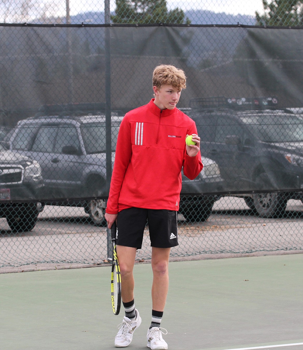Owen Larson gets ready to serve in his doubles match against Lake City earlier this year.