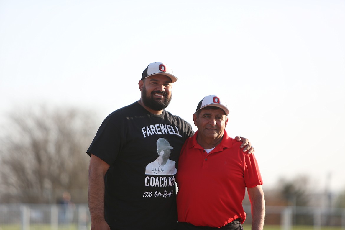 Othello Head Coach Rudy Ochoa, right, and assistant coach Rudy Ochoa II, left, smile for photos on Friday night.