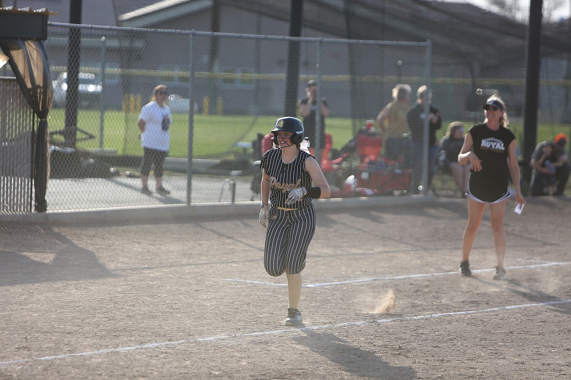 Royal senior Addi Lawrence runs to home plate with a smile after hitting her first home run of the season during the third inning of Tuesday’s nightcap against Warden.