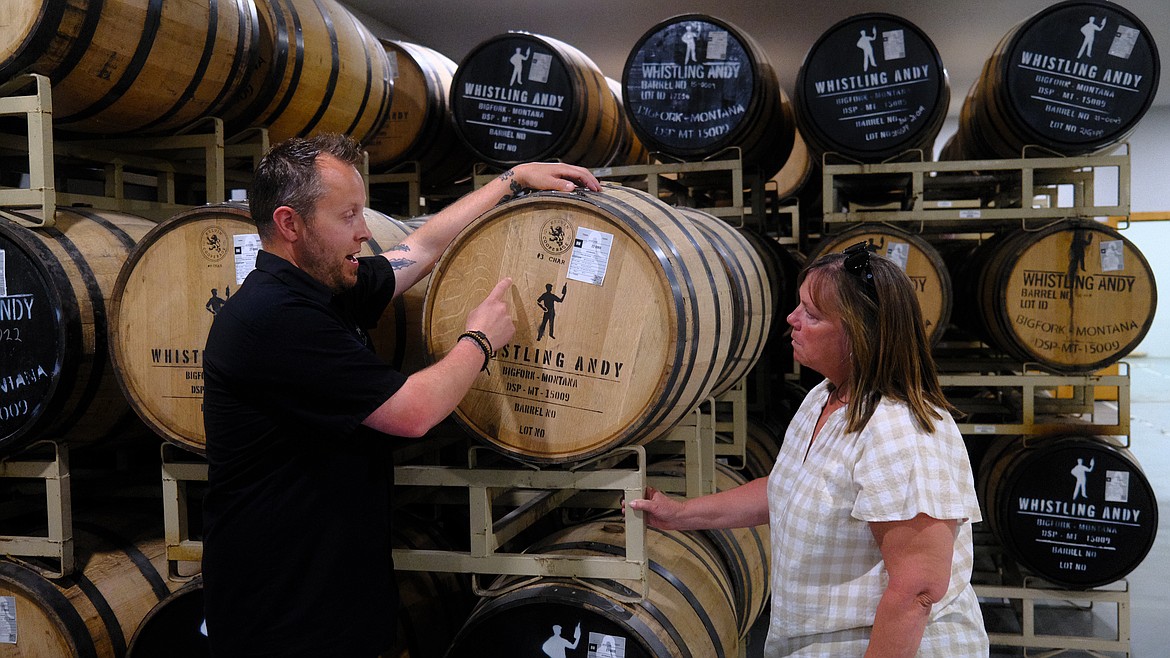 Head Distiller Gabe Spencer talks about barrel-aged whiskey with Montana Department of Agricultural Director Christy Clark at Whistling Andy distillery in Bigfork on May 4, 2023. (Adrian Knowler/Daily Inter Lake)