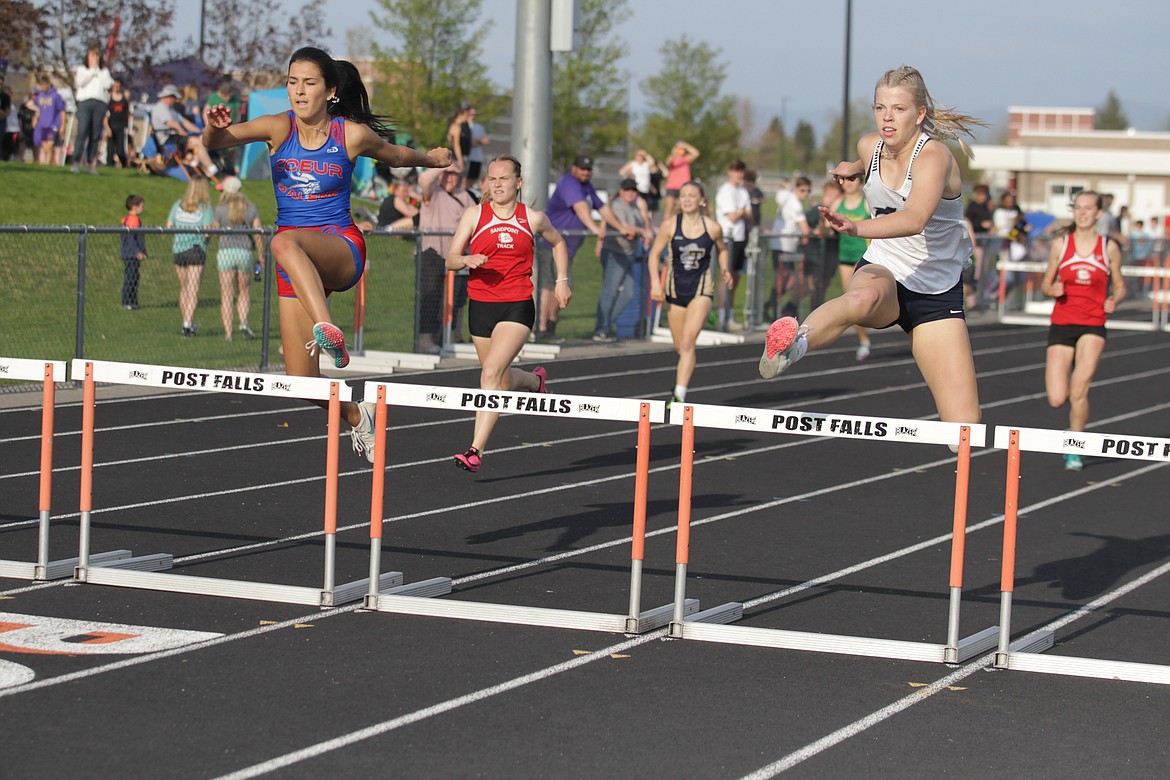 JASON ELLIOTT/Press
Coeur d'Alene junior Madison Mitchell, left, and Lake City senior Georgia Whitehead clear the second-to-last hurdle on the way to the finish line in the 300-meter hurdle race at the District 1 All-Star Meet at Post Falls High on Thursday. Whitehead won the race in 48.11 seconds, followed by Mitchell in 48.15.