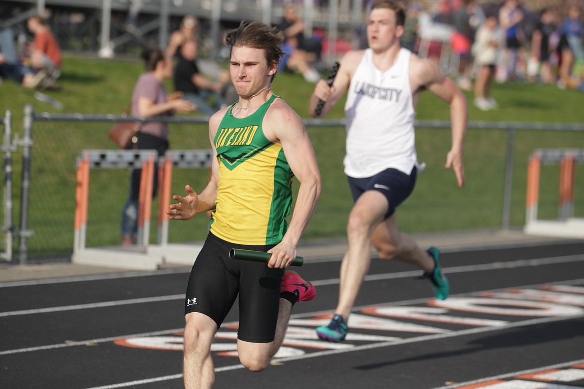 JASON ELLIOTT/Press
Lakeland sophomore Weston Saputski pulls away from Lake City senior Zach Johnson in the final 50 meters of the boys 4x100 relay at the District 1 All-Star Meet on Thursday at Post Falls High.