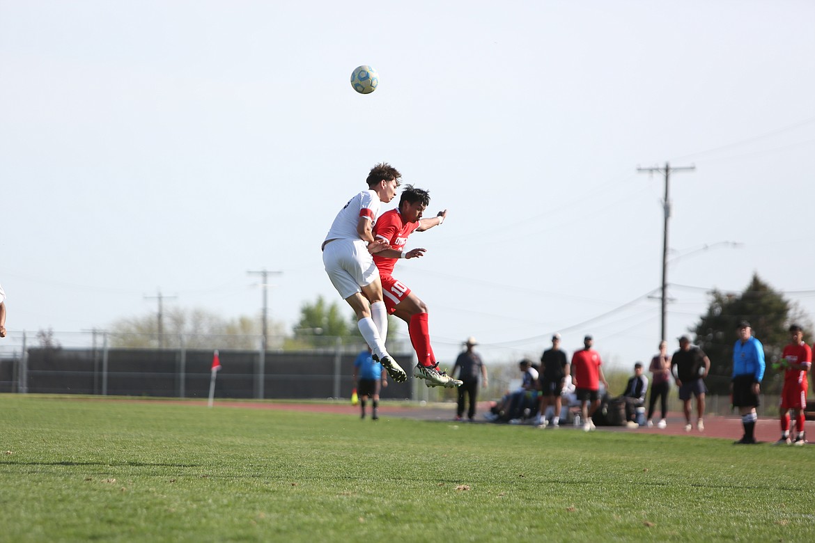 Othello junior Jose Cabrera, in red, leaps up to head the ball in the first half against Grandview on Wednesday. Caberera scored a goal in the second half to give the Huskies a 2-1 lead in the 58th minute.