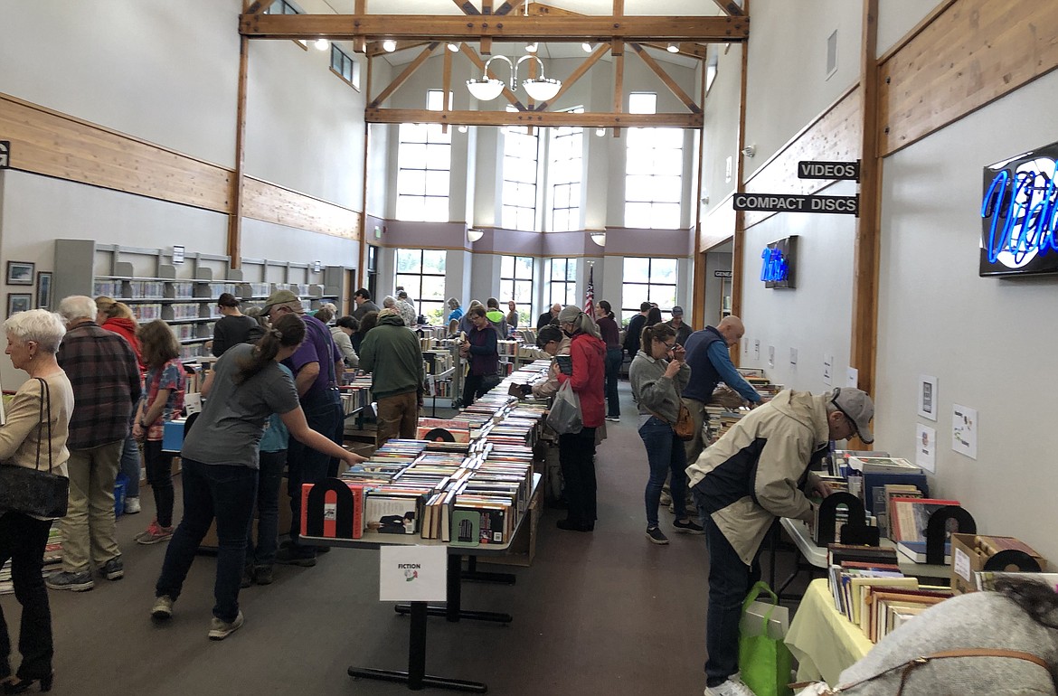 Reading enthusiasts scour the stacks during a past Friends of the Community Library Network Spring Sale. This year's sale will be from 3-7 p.m. May 19 and 10 a.m. to 3 p.m. May 20 at the Hayden Library.