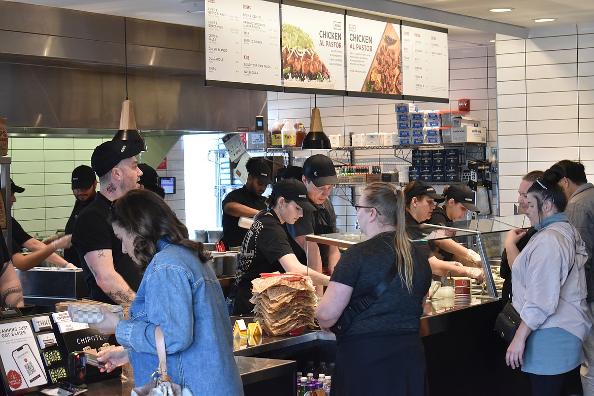 The staff at Chipotle in Moses Lake scrambles to keep up with the crowd of customers on Saturday, the restaurant’s first day open to the public. Chipotle, which specializes in burritos, quesadillas and tacos, is located at 2345 S. Maiers Road.