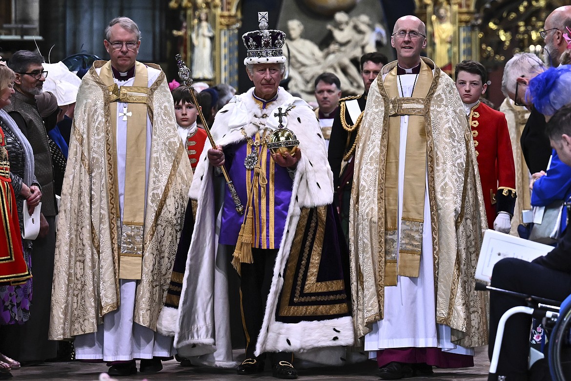 Britain's King Charles III wearing the Imperial state Crown and carrying the Sovereign's Orb and Sceptre leaves Westminster Abbey after coronation in central London Saturday, May 6, 2023. The set-piece coronation is the first in Britain in 70 years, and only the second in history to be televised. Charles will be the 40th reigning monarch to be crowned at the central London church since King William I in 1066. (Ben Stansall/POOL photo via AP)