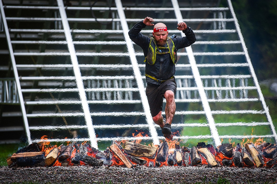 Nephi Roundy, of Monteview, Idaho, clears the fire jump near the finish line of the Beast 21K race at the Montana Spartan Trifecta in Bigfork on Saturday, May 6. (Casey Kreider/Daily Inter Lake)