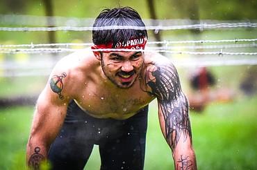 Gil Parent, from Milbank, South Dakota, navigates through the barbed wire crawl obstacle at the Montana Spartan Trifecta in Bigfork on Saturday, May 6. (Casey Kreider/Daily Inter Lake)