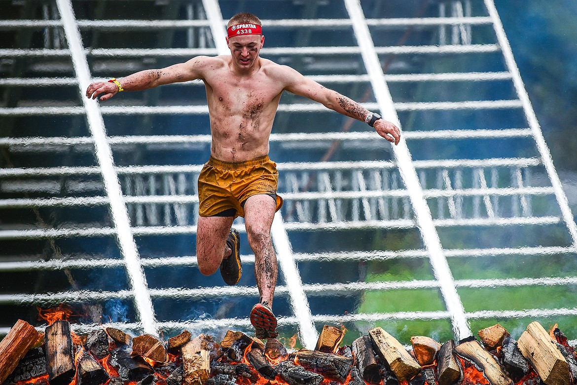 Isaac Stowell, of Gilbert, Arizona, clears the fire jump near the finish line of the Beast 21K race at the Montana Spartan Trifecta in Bigfork on Saturday, May 6. (Casey Kreider/Daily Inter Lake)