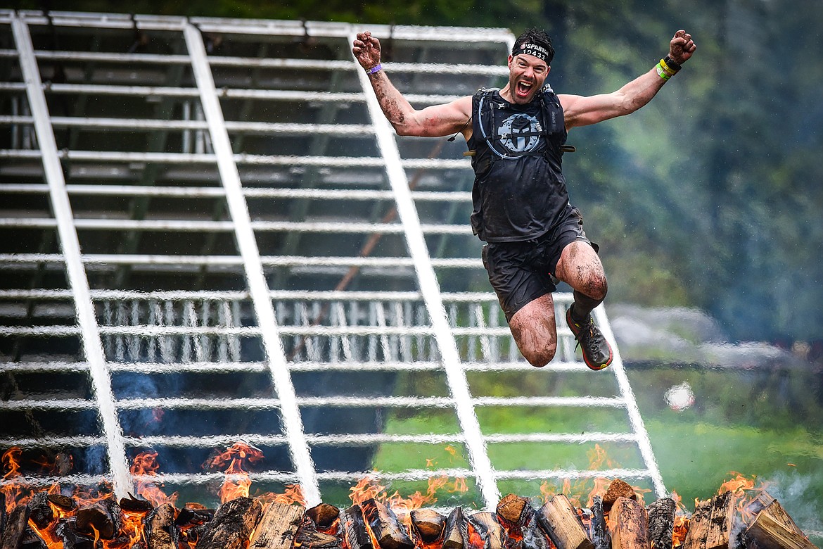 Nathan Harris-Thompson, of Calgary, Alberta, Canada, clears the fire jump near the finish line of the Beast 21K race at the Montana Spartan Trifecta in Bigfork on Saturday, May 6. (Casey Kreider/Daily Inter Lake)