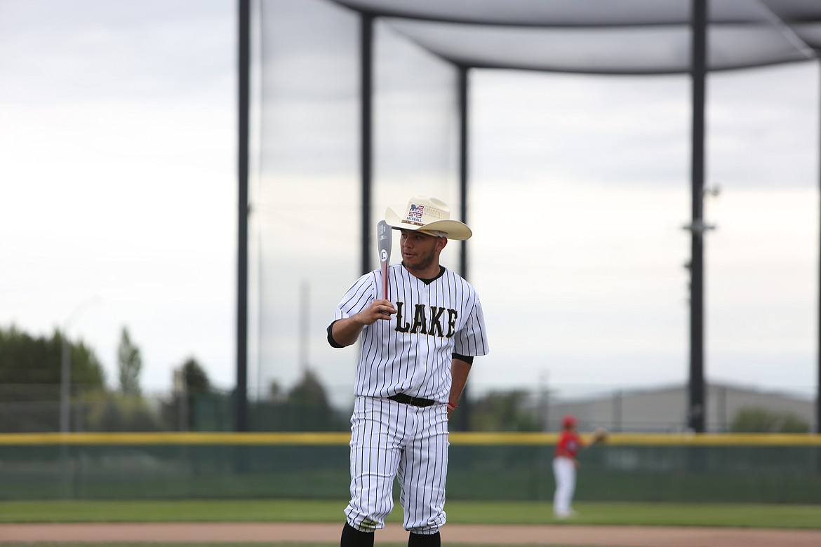 Moses Lake senior Peyton Juarez gets ready for photos during the team’s senior night ceremony. Seniors received a cowboy hat with the team’s logo and a baseball bat commemorating their graduating year.