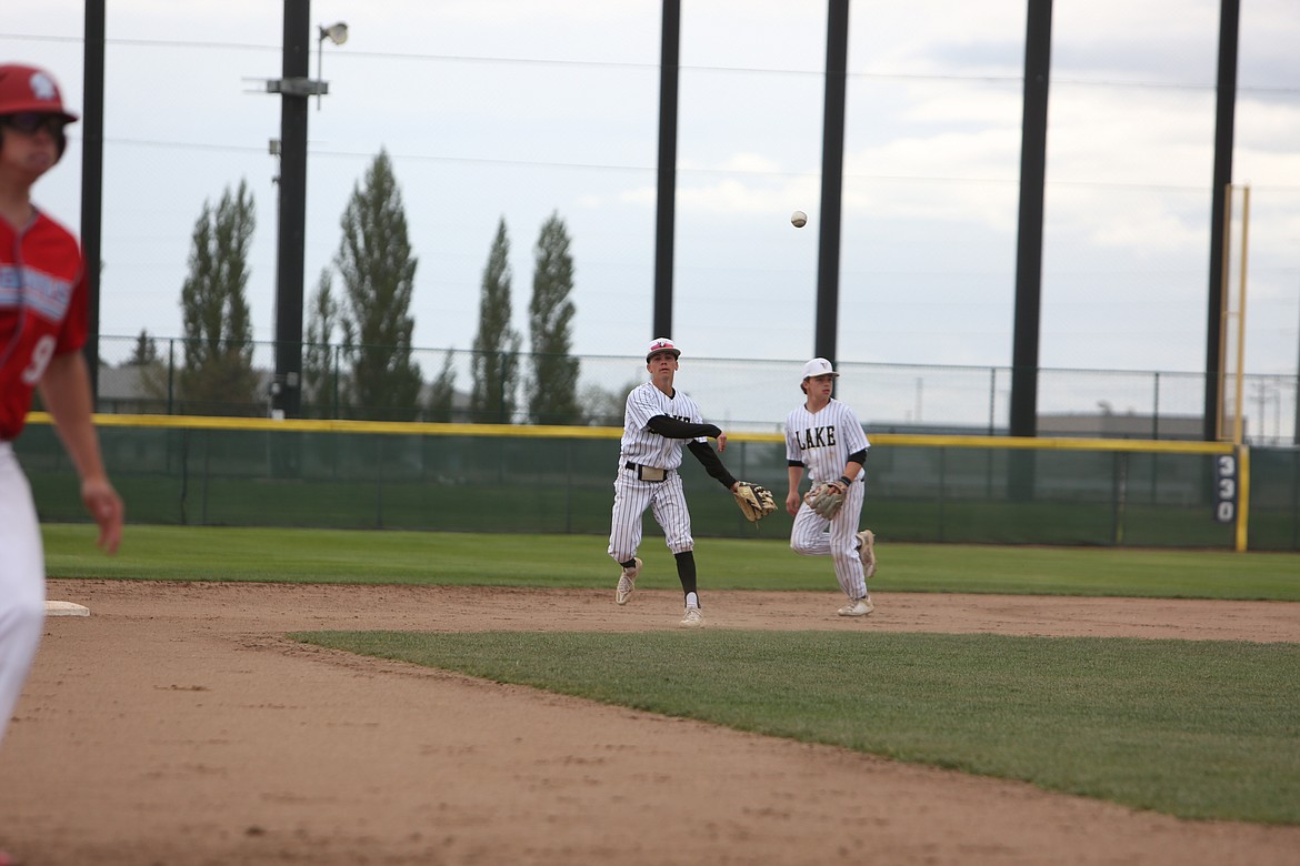 Moses Lake junior Jayce Stuart, center, throws a ball toward third base against West Valley (Yakima) on Friday.