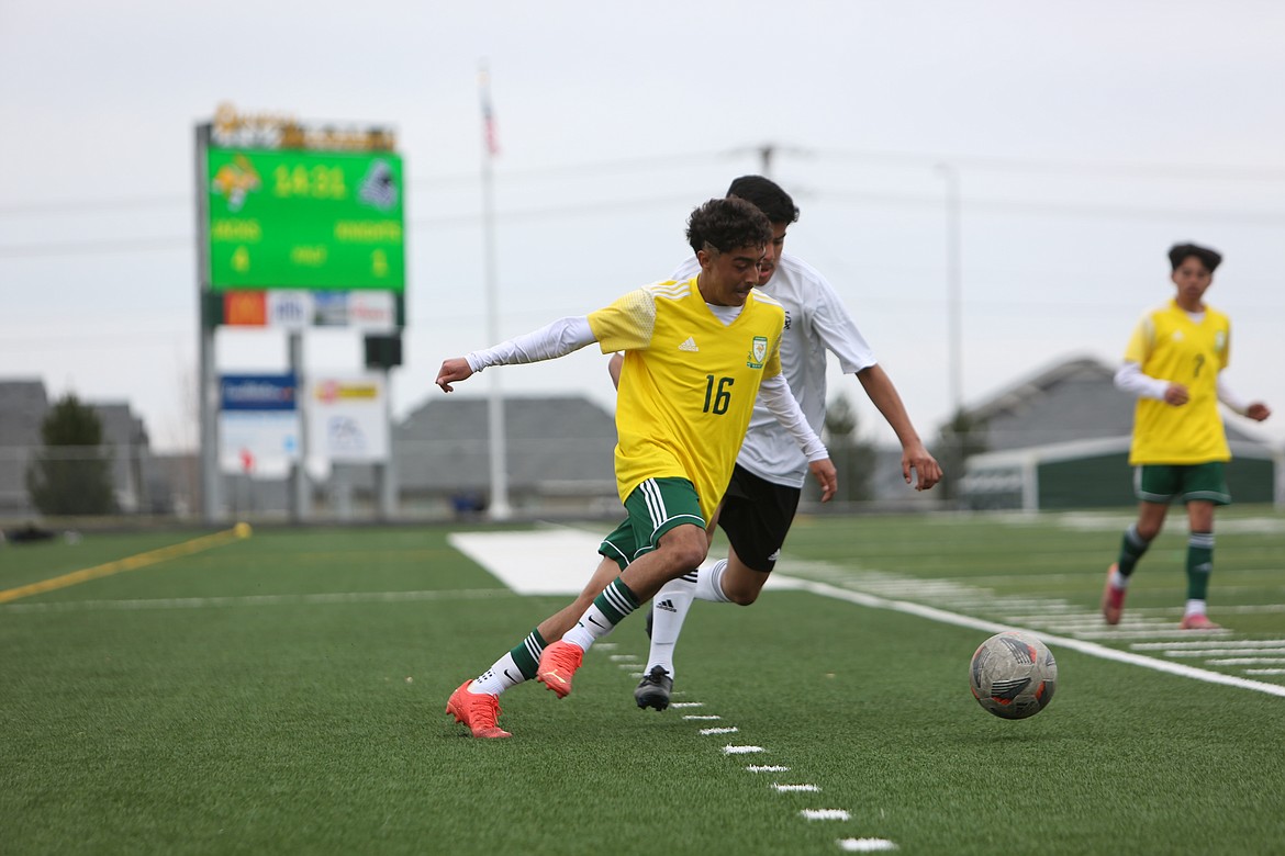 Quincy junior Alexander Murillo pushes the ball upfield against Royal on April 15.