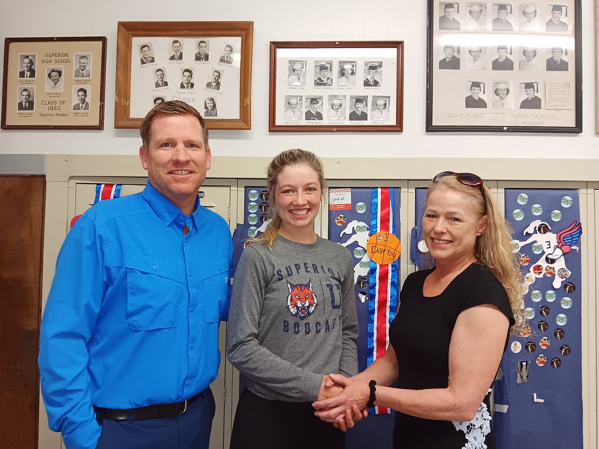 Byron Quinlan, Superior High School counselor, and Merry Mueller, Mineral County Superintendent of Schools and Treasure, congratulate Darby Haskins on being the recipient of the Gaylord Green scholarship for 2023. Haskins will be attending the University of Montana. (Monte Turner/Mineral Independent)