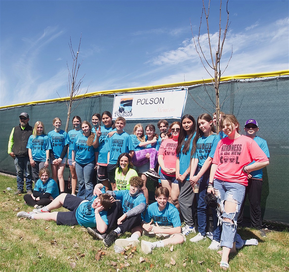 Polson Parks and Recreation Director Patrick Nowlen, left, and teacher Nicole Camel, center, pose with eighth graders from Polson Middle School as they prepared to celebrate Arbor Day recently by planting three new trees at O'Malley Park. (Kristi Niemeyer/Leader)