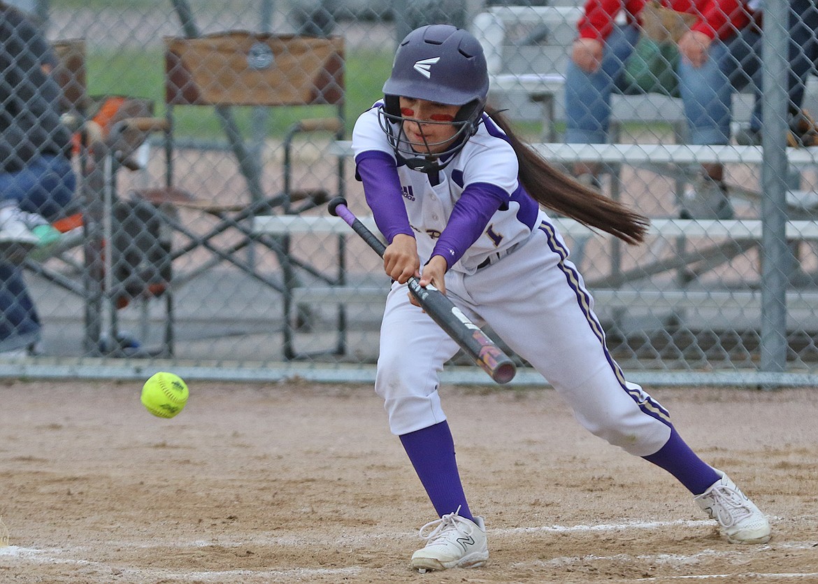 Polson's Jaja Nichols stretches for a bunt during rainy game against Browning. (Bob Gunderson photo)