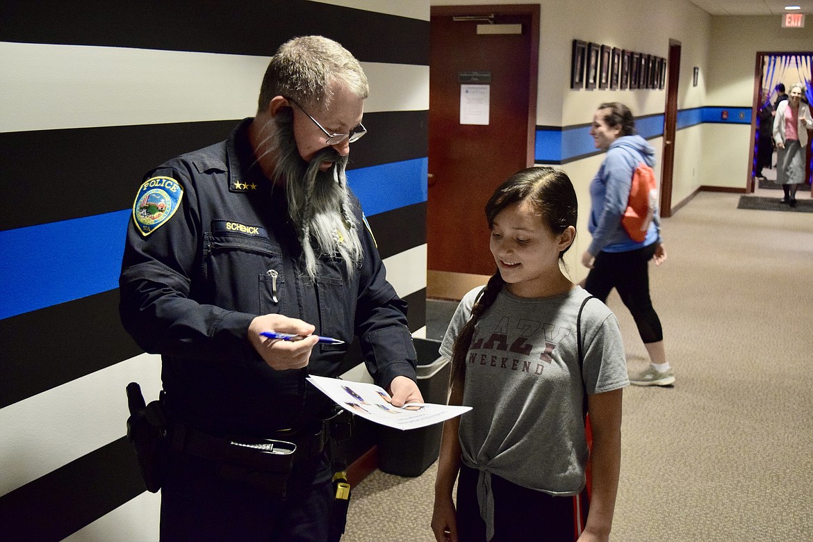 Wearing a crazy beard for the occasion, Phil Schenck talks with a student at the OPD open house in 2019.