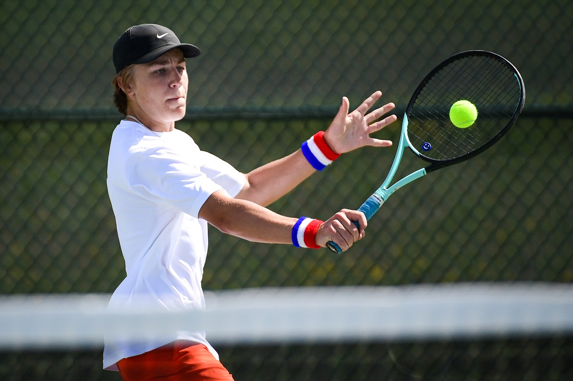 Flathead's Kobe Schlegel hits a backhand return in a boys singles match against Glacier's Kutuk White at FVCC on Tuesday, May 9. (Casey Kreider/Daily Inter Lake)