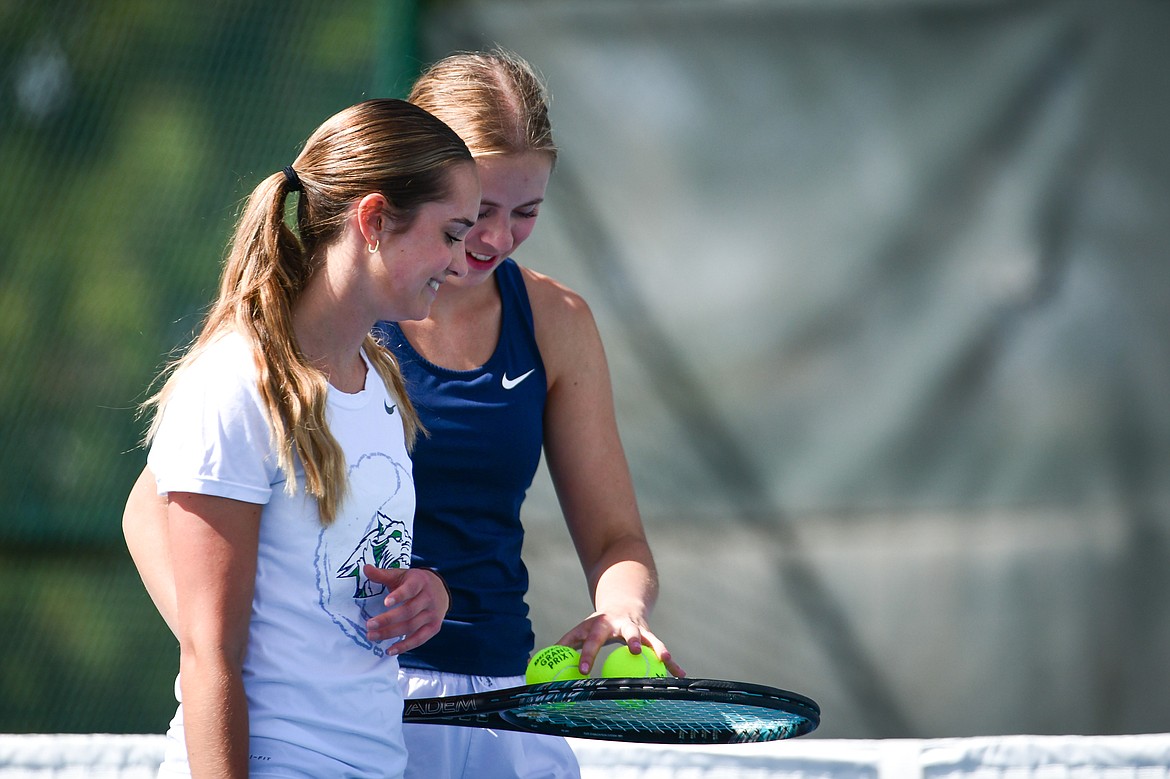 Glacier's Haven Speer and Sarah Downs talk between sets against Flathead's Clara Jones and Emmary Faerber at FVCC on Tuesday, May 9. (Casey Kreider/Daily Inter Lake)