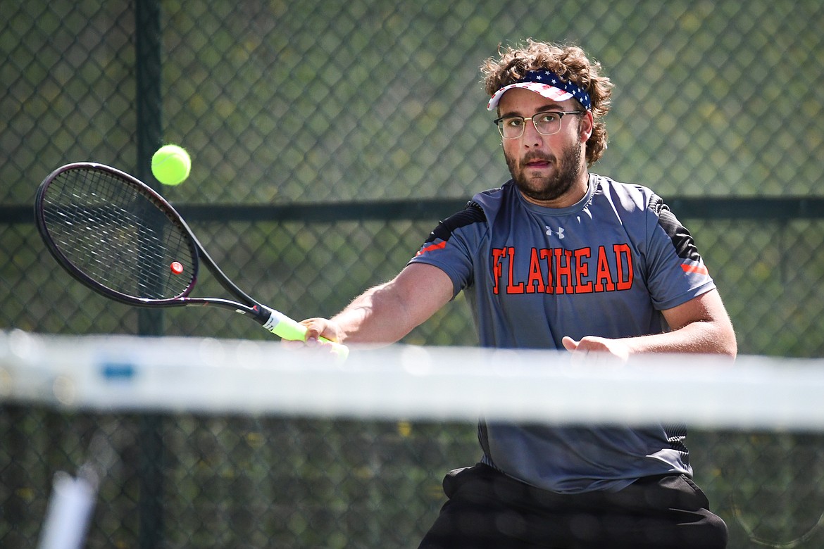 Flathead's Quaid Ring hits a return in a boys singles match against Glacier's Will Rudbach at FVCC on Tuesday, May 9. (Casey Kreider/Daily Inter Lake)