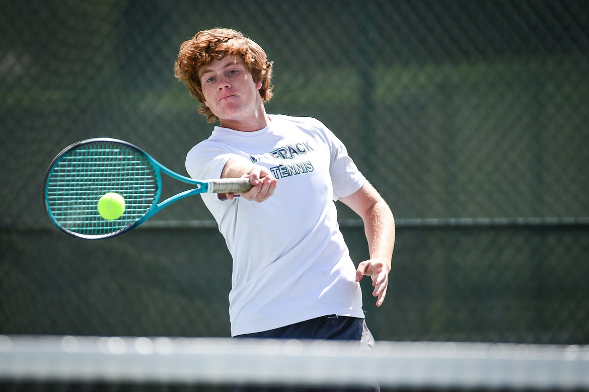 Glacier's Timmy Glanville hits a return in a boys doubles match with teammate Harrison Sanders against Flathead's Ezias Bailey and Tyler Shawback at FVCC on Tuesday, May 9. (Casey Kreider/Daily Inter Lake)