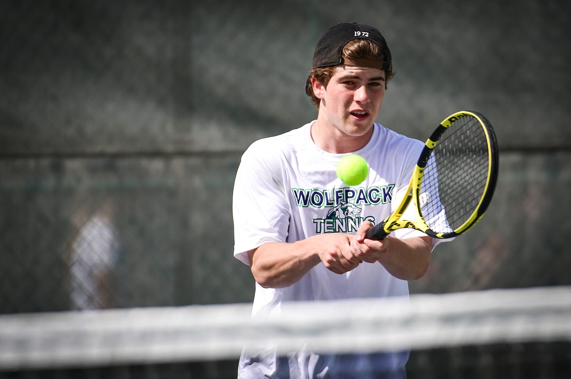 Glacier's Harrison Sanders hits a backhand return in a boys doubles match with teammate Timmy Glanville against Flathead's Ezias Bailey and Tyler Shawback at FVCC on Tuesday, May 9. (Casey Kreider/Daily Inter Lake)