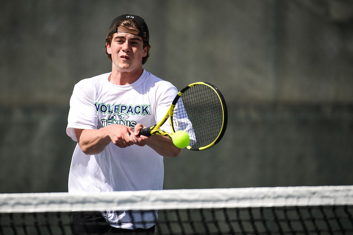 Glacier's Harrison Sanders hits a backhand return in a boys doubles match with teammate Timmy Glanville against Flathead's Ezias Bailey and Tyler Shawback at FVCC on Tuesday, May 9. (Casey Kreider/Daily Inter Lake)