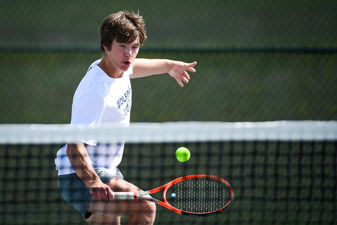 Glacier's Kutuk White hits a backhand return in a boys singles match against Flathead's Kobe Schlegel at FVCC on Tuesday, May 9. (Casey Kreider/Daily Inter Lake)