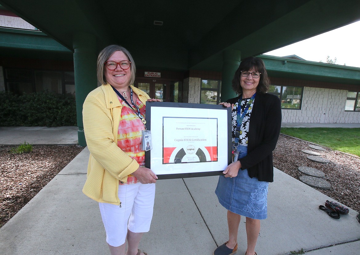 Fernan STEM Academy Principal Kathy Livingston, left, and Assistant Principal Sandy Doering on Tuesday display the school's new STEM designation from Cognia, a distinguished accreditation and certification organization.