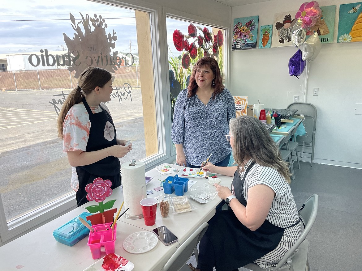 Krista Courier (center), with her sister Tessa Johnstone (right) and niece Macey Johnstone at Courier’s new business, The Creative Studio by Rustic Girl Painting, at 1001 W. Broadway Ave. in Moses Lake. Johnstone said she and her daughter came all the way from Pullman to help Courier get her business opened. “She used to be insecure about her painting, and now she has a whole business where she teaches people how to do it,” Johnstone said. “She’s amazing.”