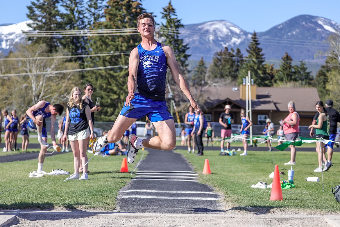 Bryce Dunham competes in the triple jump at the Cat-Dog meet on Tuesday in Whitefish. (JP Edge photo)